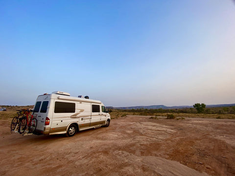 Van parked in the desert at a campground outside of Arches National Park.