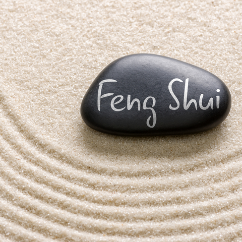 Sand and a rock that says Feng Shui