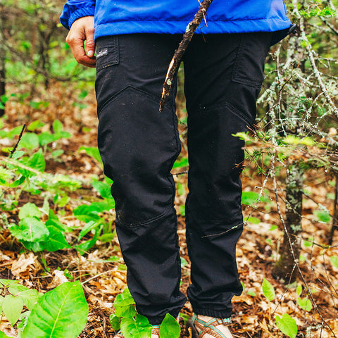 Woman wearing Boundary waters shell pants in the BWCA MN woods