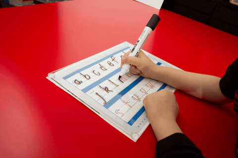 Child writing on the Writeboard, clear writing board for kids