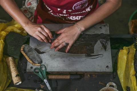 Hand rolling premium bourbon barrel fermented cigars