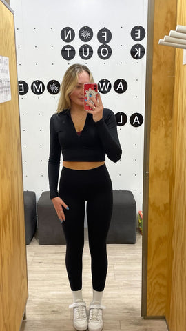 A woman wearing a new Ryderwear branded activewear set in black