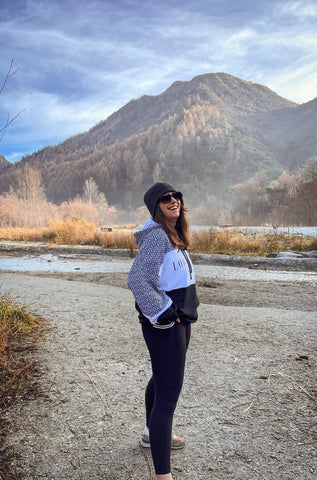 Ali in front of the Arrow River in Arrowtown NZ. She wears the new season Lorna Jane Retro Recoup Oversized Hoodie in Mono Argyle paired with the Swift Heritage Pocket Ankle Biter Leggings in Black