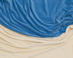 folds of blue and ivory organic cotton fabric swirled together 