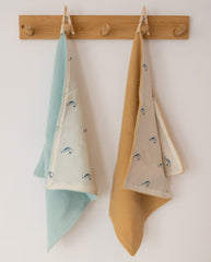 Two lovey's hanging side by side on wooden hooks, mint green and tan