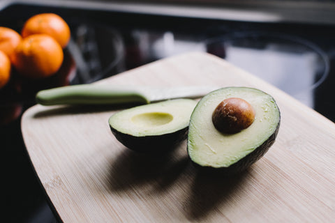 Some avocados on a cutting board.