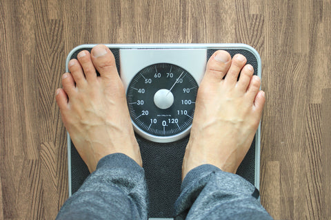 Male on the weight scale for check weight