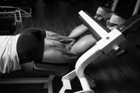 Bodybuilder Doing Heavy Weight Exercise For Legs Hamstrings