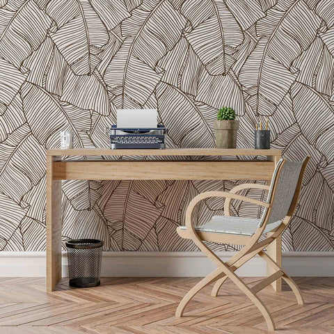 A room with wallpaper with giant leaves drawn in contour lines