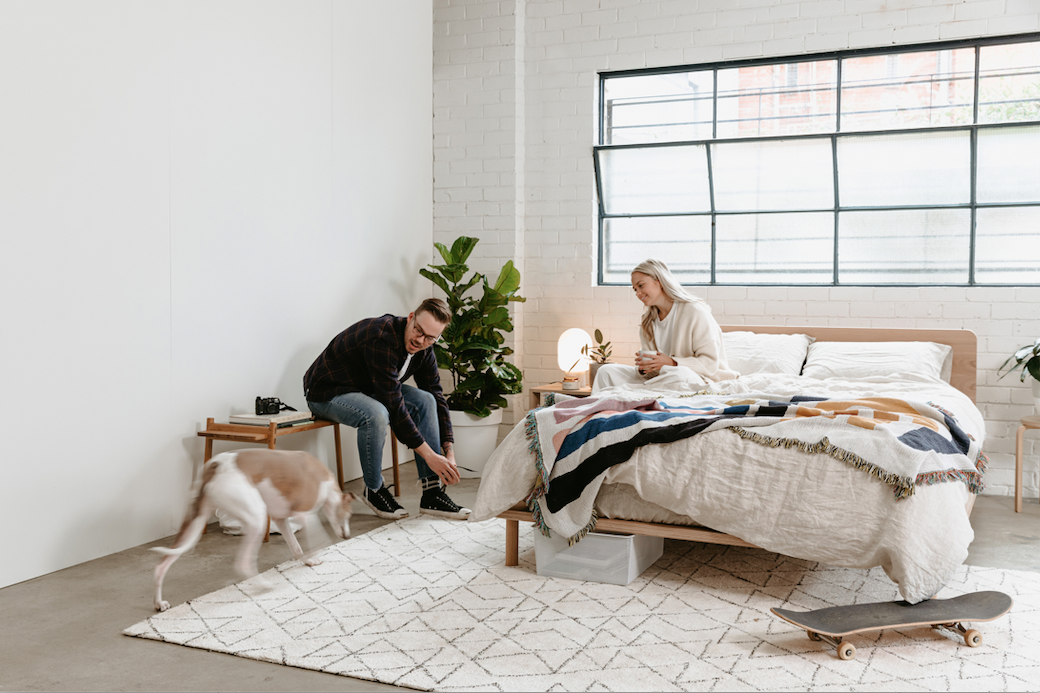 Guy & girl on Eva Bed with dog