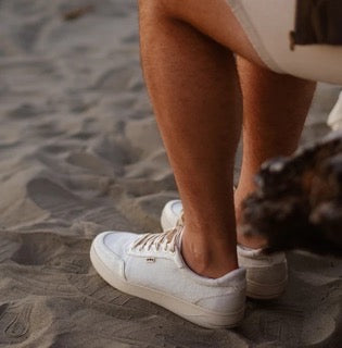man wears Orba shoes on the beach