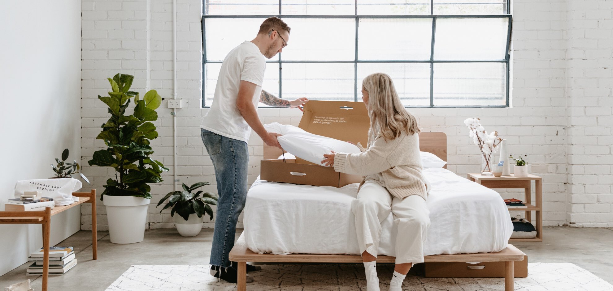 Two people unboxing the Eva Pillow