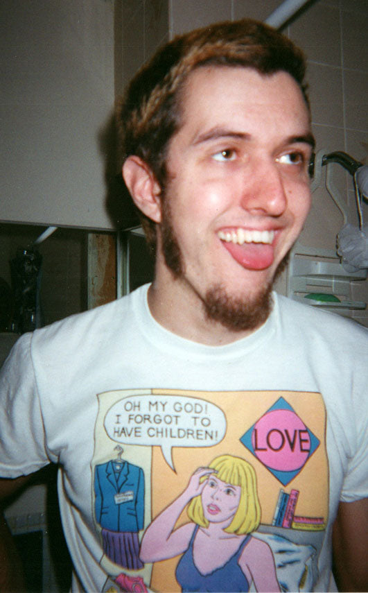 man with tongue hanging out looking upwards wearing shirt with a photo of a woman saying oh my God I forgot to have children