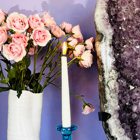 Close up altar with candle and huge amethyst