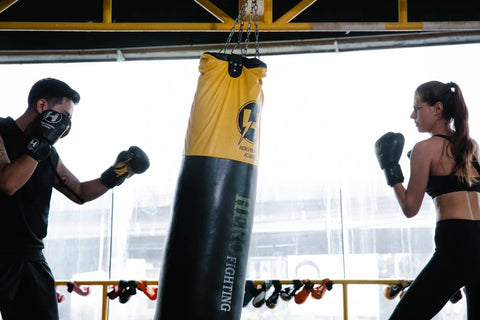 man training woman in a boxing workout