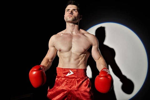 shirtless man wearing boxing gear