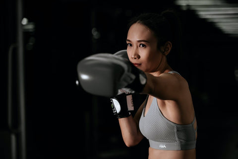 woman boxing while wearing gloves