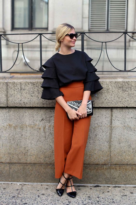 modest loose fitting black blouse with frills on sleeves