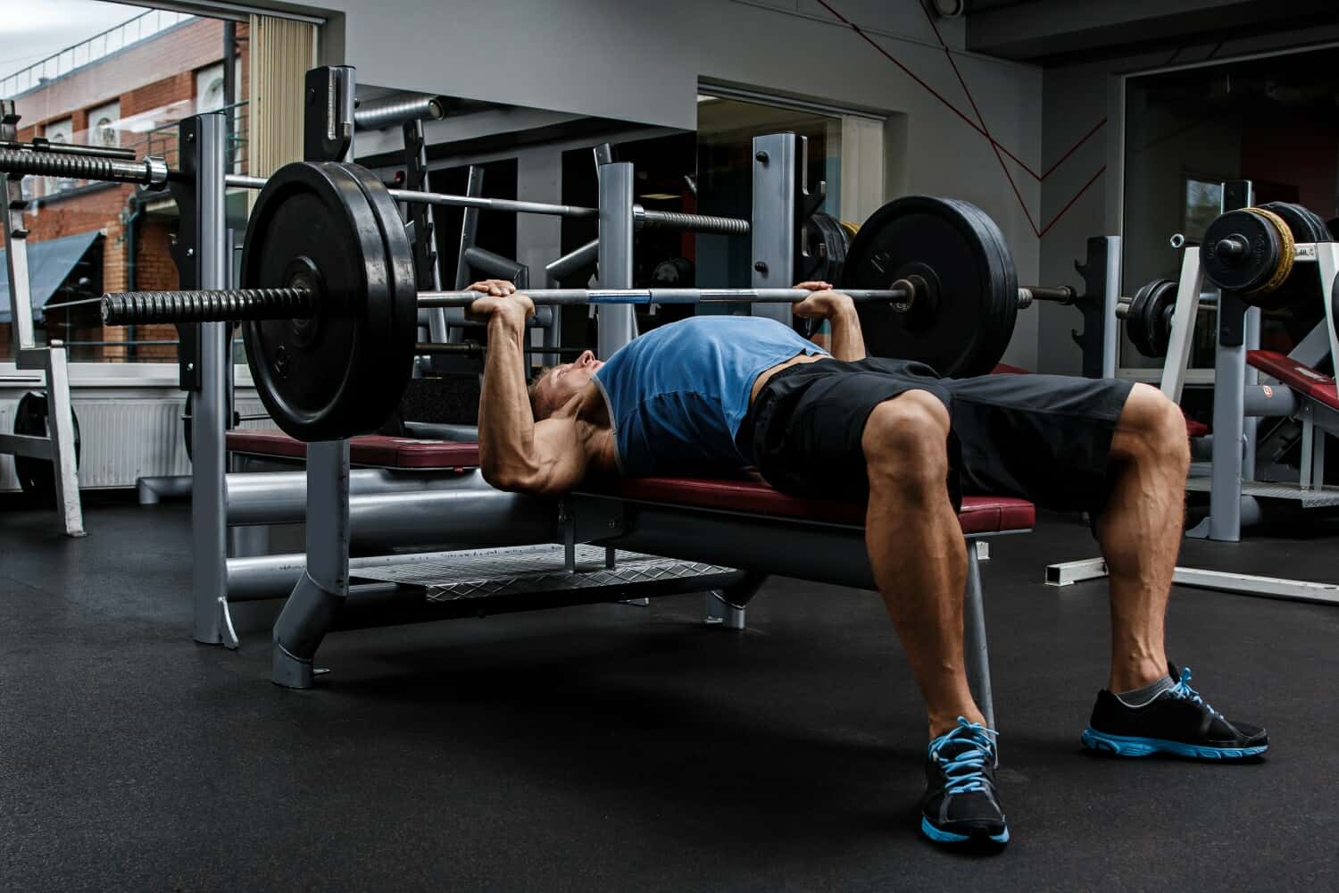 Man in blue shirt doing a bench press