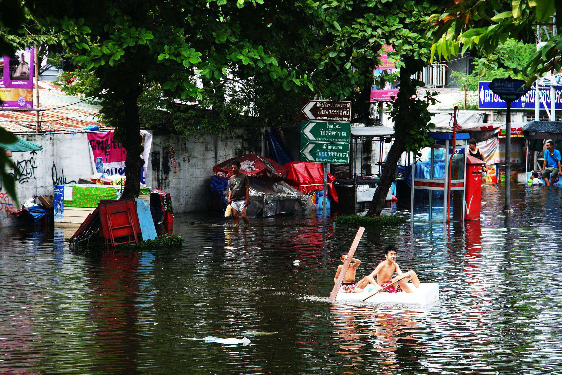 boy floating on raft during natural disaster flood