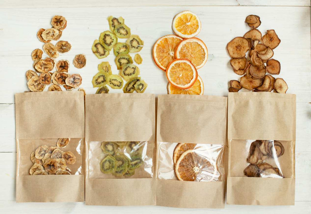 Brown and clear bags of dehydrated fruits laid out side by side