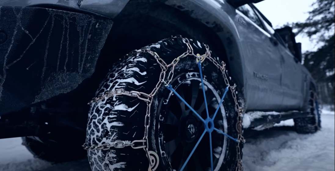 Tire chains installed on a toyota truck in the winter time