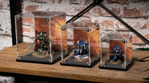 3 sizes of Warhammer Miniatures in display cases