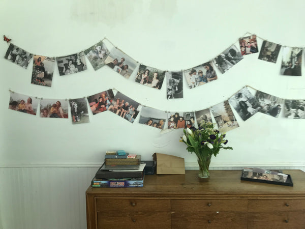 Binder clips pinning photos to twine