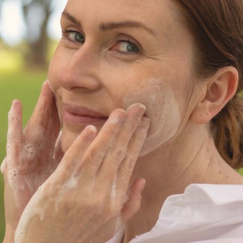 Image of a women using a cleanser