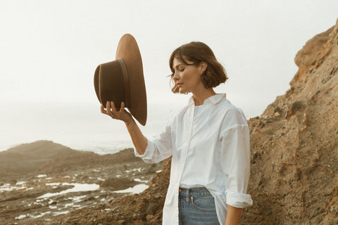 Fall/winter wool felt hat collection photoshoot in Laguna Beach, California featuring the Elise fedora in brown