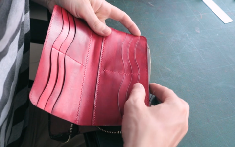 Attaching the leather interior with the body of the zipper wallet