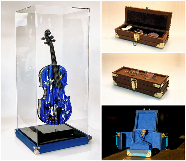 variety of works made by JM malles, a violin case, a glasses cases and a more traditional trunk