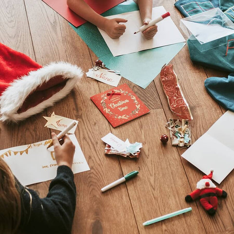 Children creating their own homemade Christmas cards.