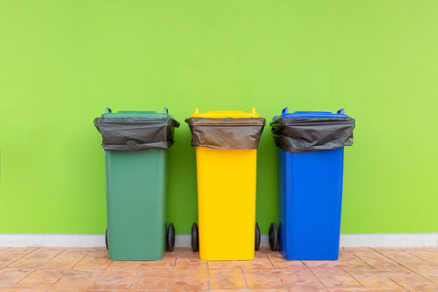 colourful wheelie bins against a colourful wall