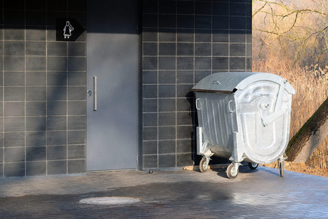 A large metal wheelie bin outdoors