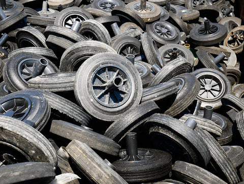 Wheelie bin wheels in a pile.