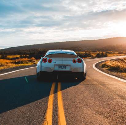 Driving on an open road at sunset