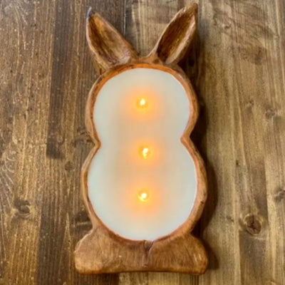 A lit bunny shaped dough bowl candle