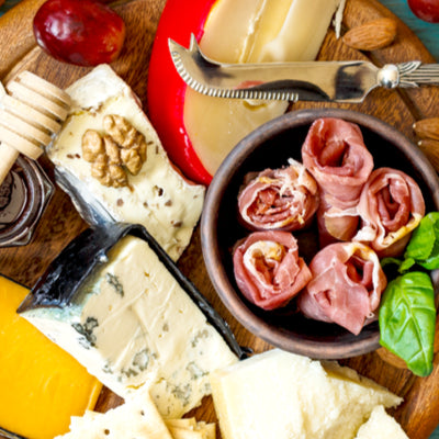 Selecting meats and cheeses for a charcuterie board
