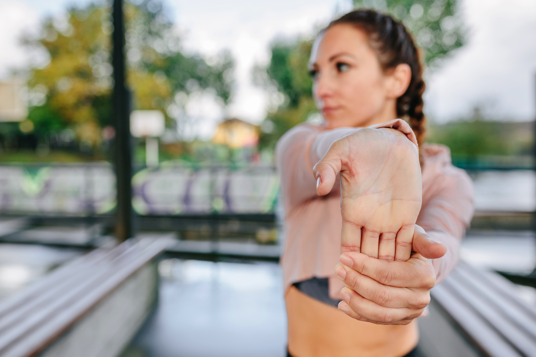 Woman with arm extended stretching wrist