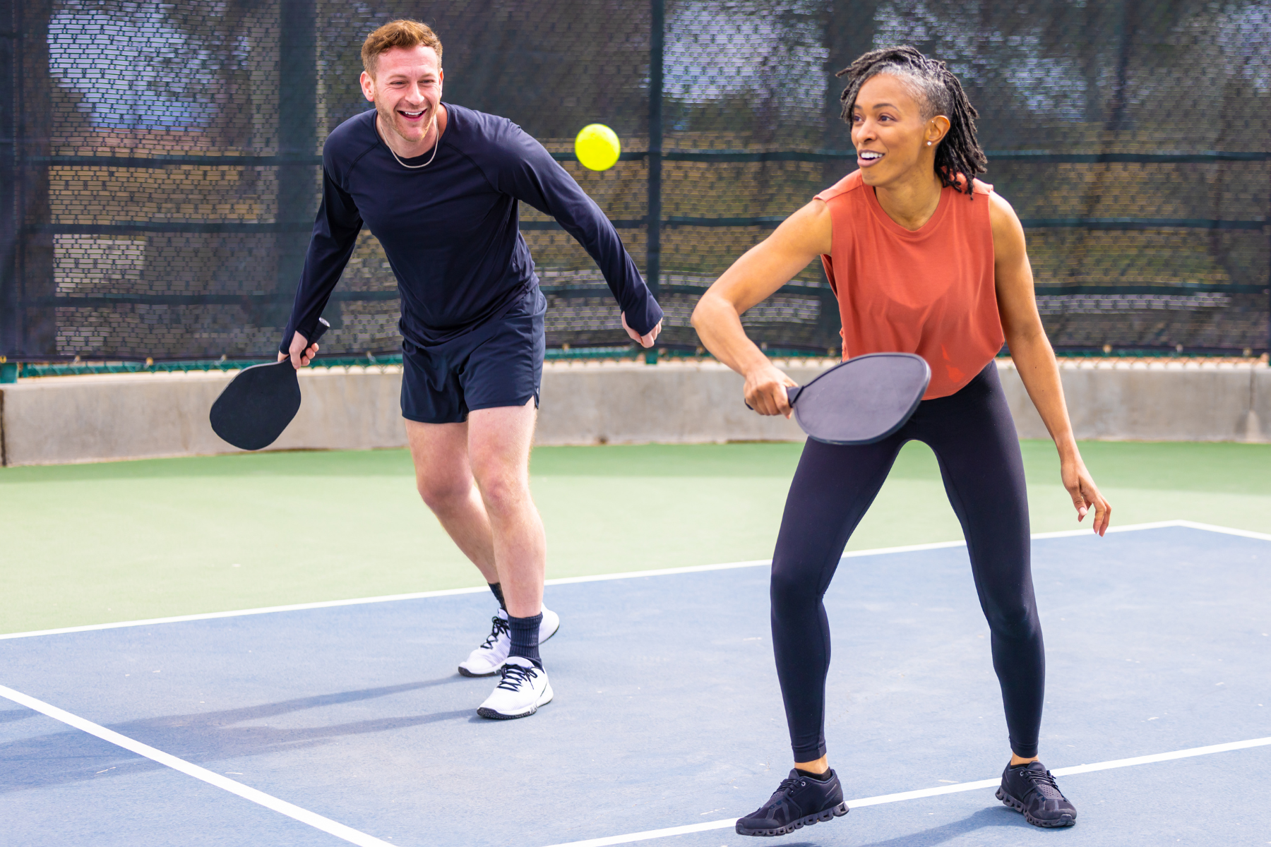 man and woman playing pickleball