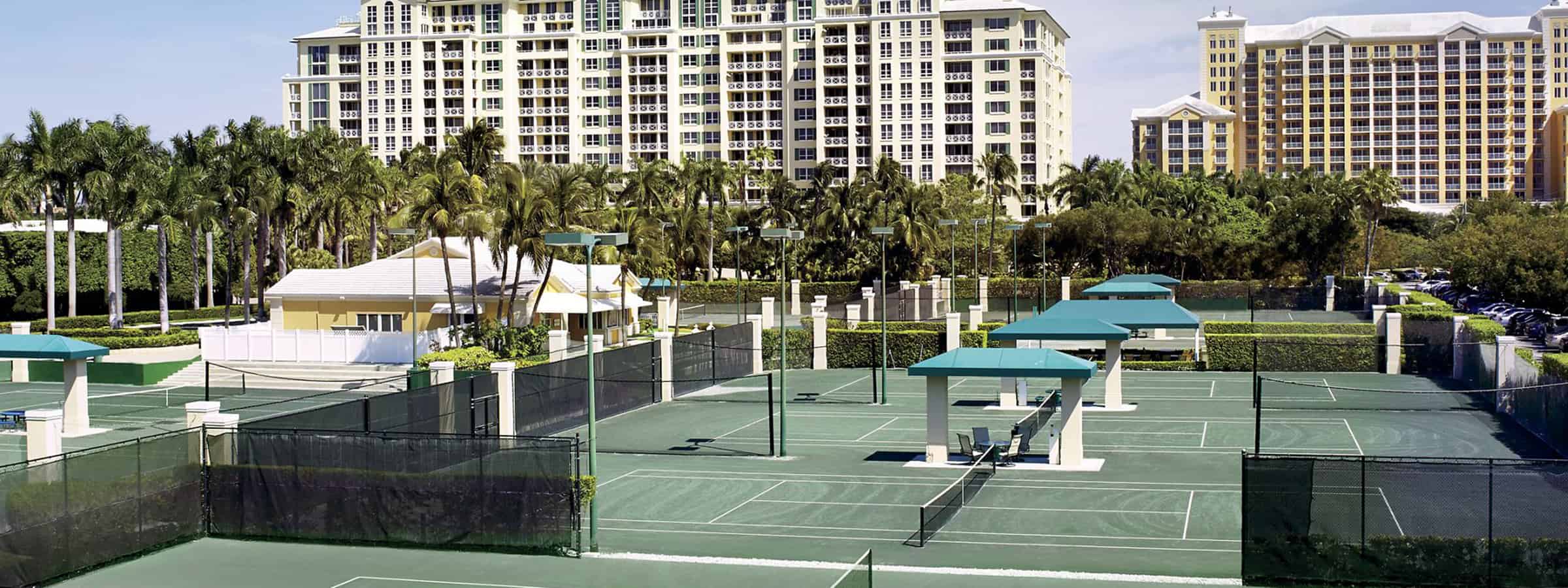 Tennis courts with office building in the background