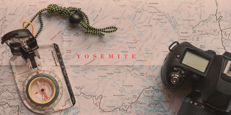 Compass and camera on map of Yosemite National Park