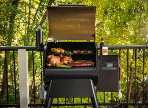 Traeger grills smoker grill with meat and veggies on it