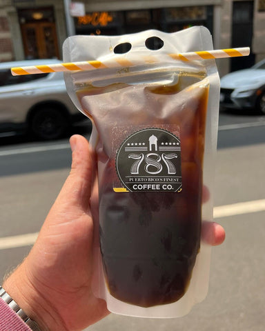 hand holding an iced coffee by 787 Coffee Co.