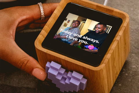 hand holding a Lovebox device for sending personalized messages to your loved ones