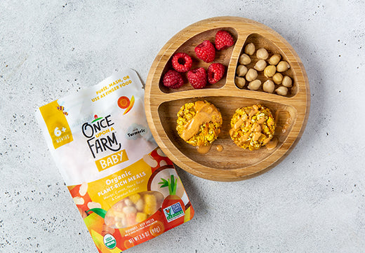 mango and carrot patties on a plate with raspberries and chickpeas