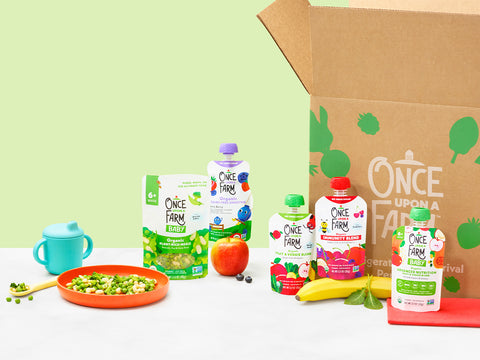once upon a farm plant-rich meal and fruit and veggie blend pouches next to an open subscription box