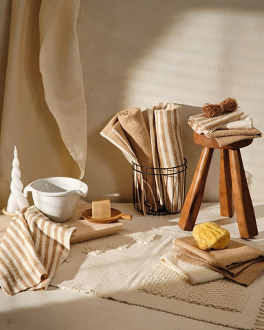 various homemade textiles and home goods on a beige backdrop