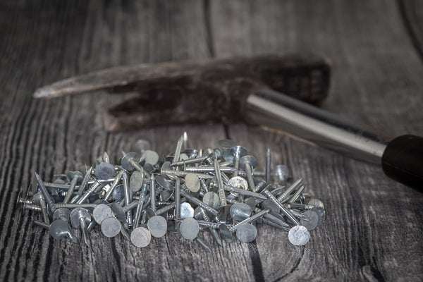 installing shingles on a shed